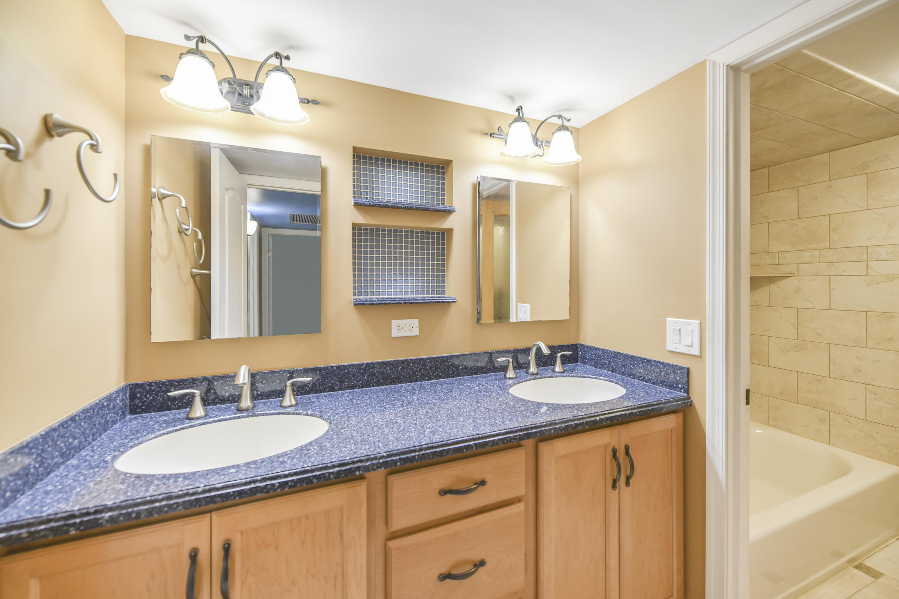 102 Woodland Road Palm Springs, FL 33461 - Photo 37 of 41 a bathroom with a granite countertop sink and a mirror