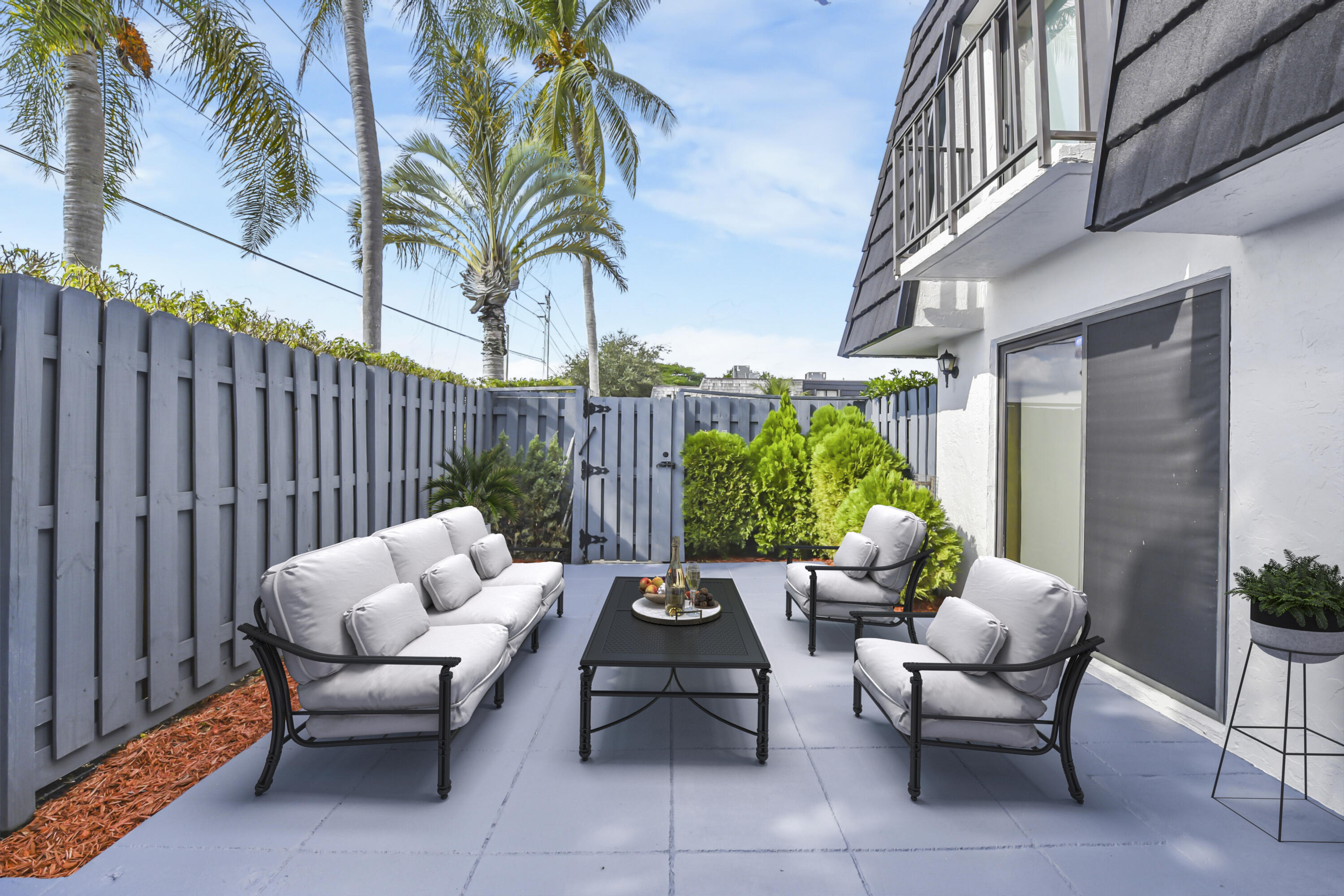 102 Woodland Road Palm Springs, FL 33461 - Photo 6 of 41 a view of a patio with couches and a potted plant on a patio