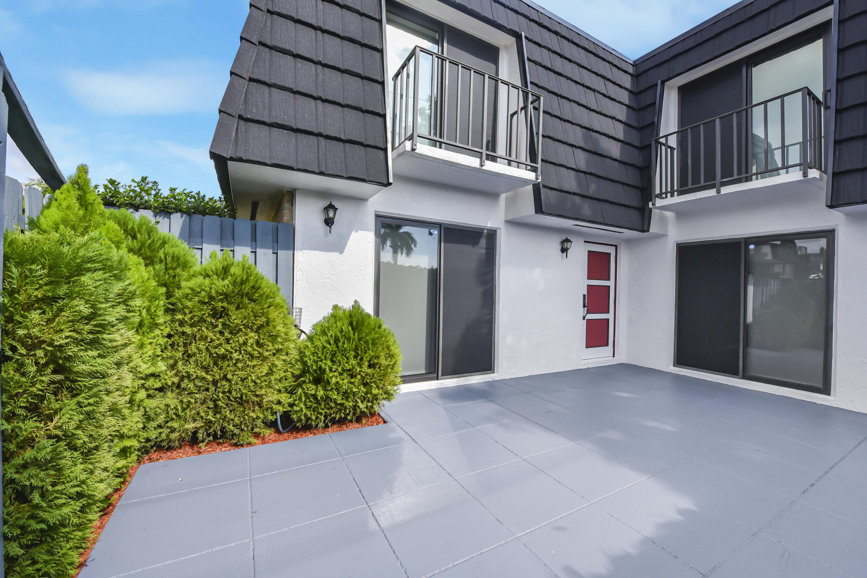 102 Woodland Road Palm Springs, FL 33461 - Photo 7 of 41 a view of a house with potted plants