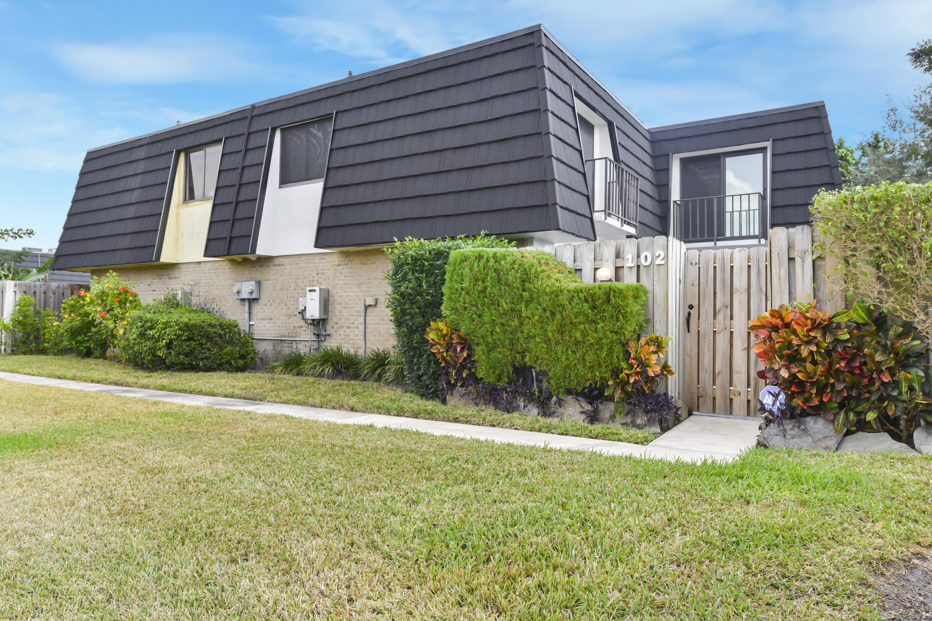 102 Woodland Road Palm Springs, FL 33461 - Photo 8 of 41 a front view of a house with garden