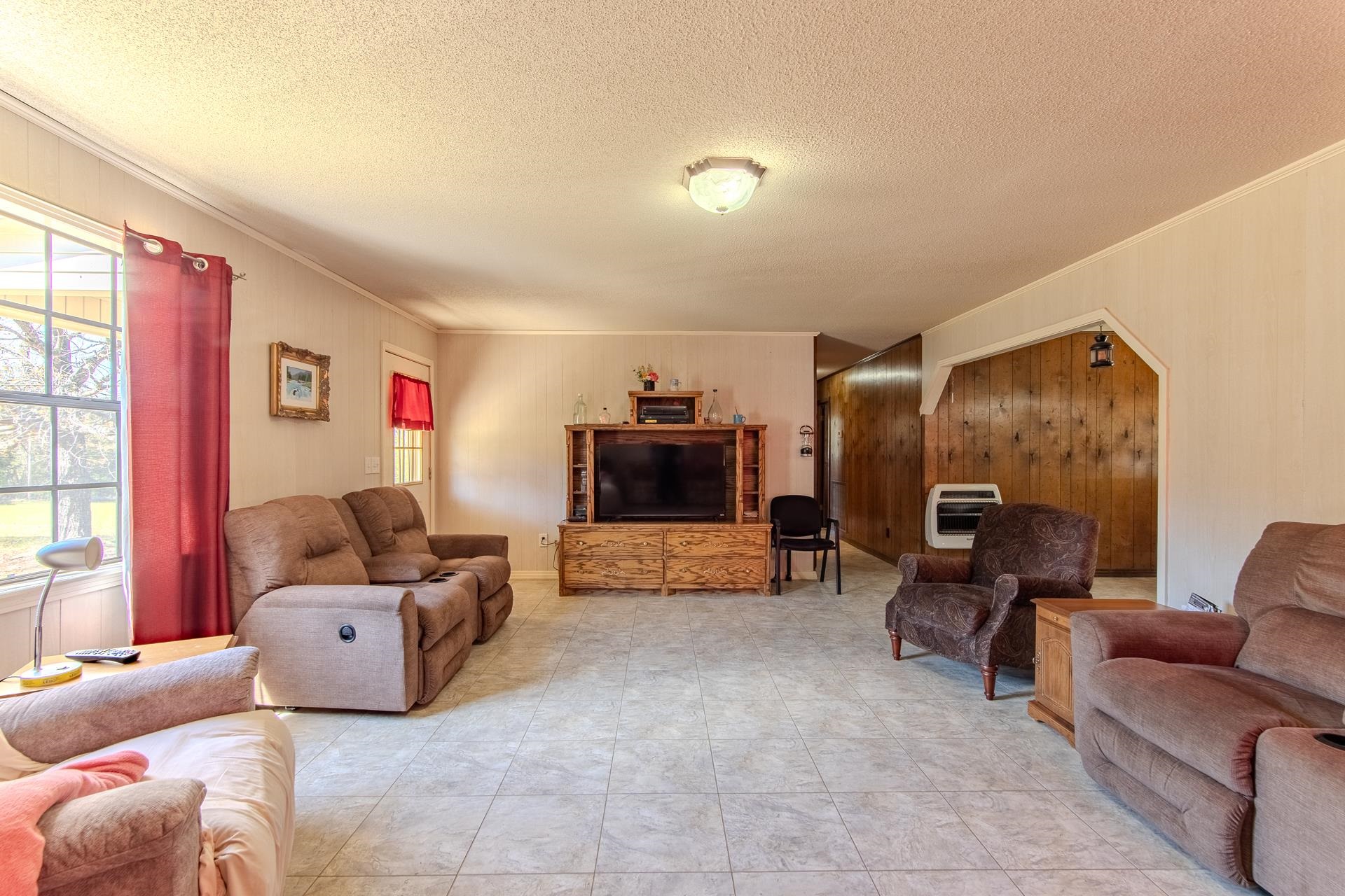 4485 Holland Creek Road Savannah, TN 38372 - Photo 13 of 39 a living room with furniture and a flat screen tv
