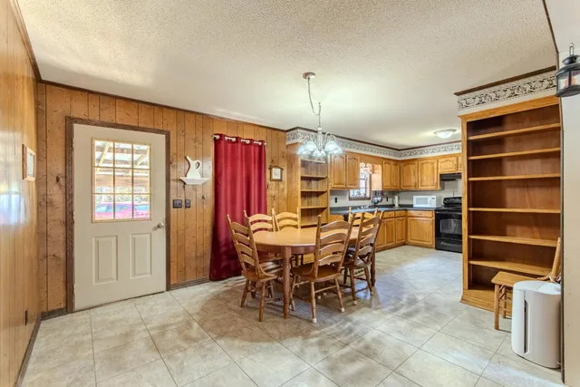 a dining room with furniture and a chandelier