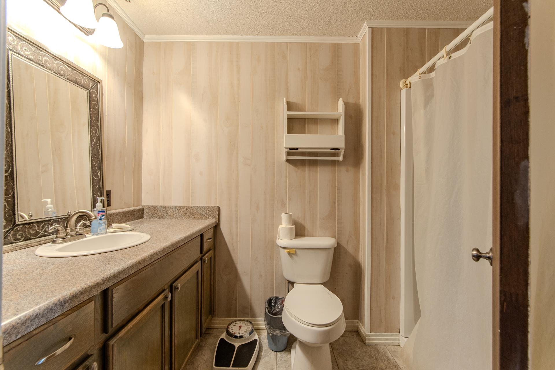 4485 Holland Creek Road Savannah, TN 38372 - Photo 22 of 39 a bathroom with a granite countertop sink toilet and shower