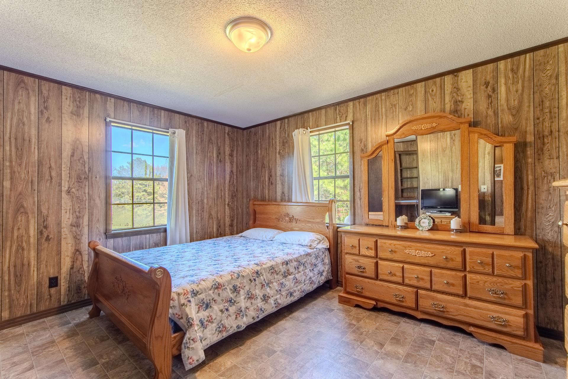 4485 Holland Creek Road Savannah, TN 38372 - Photo 26 of 39 a bedroom with a bed and large windows