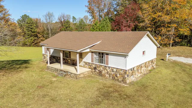 an aerial view of residential house with pool and yard