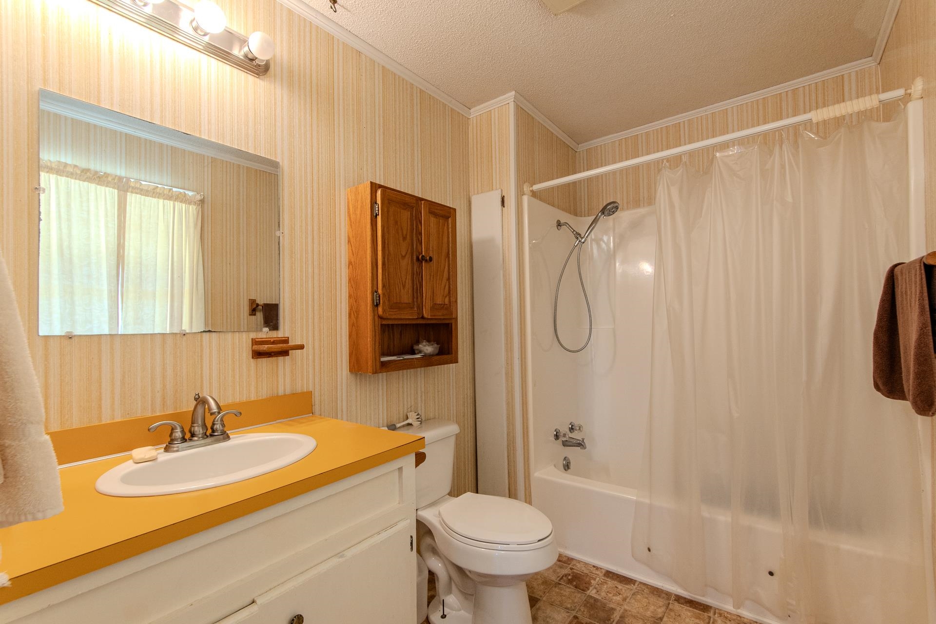4485 Holland Creek Road Savannah, TN 38372 - Photo 31 of 39 a bathroom with a sink toilet and shower
