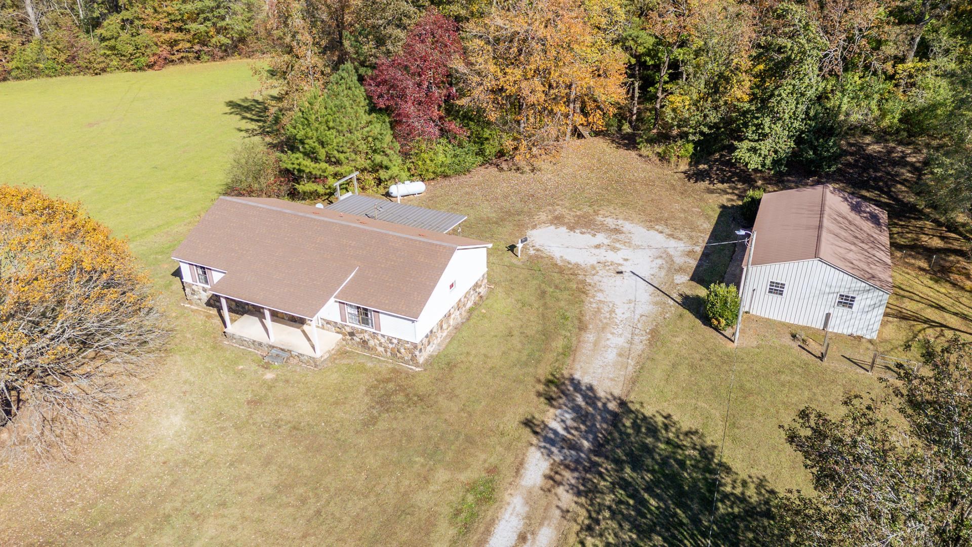 4485 Holland Creek Road Savannah, TN 38372 - Photo 9 of 39 an aerial view of a house with outdoor space and lake view