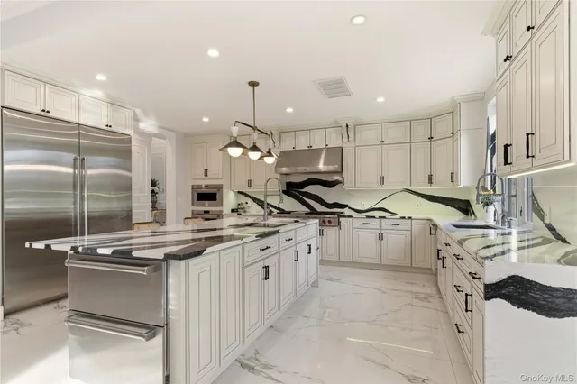 a kitchen with stainless steel appliances a sink a stove and a window