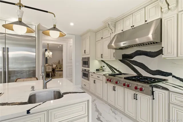 a kitchen with stainless steel appliances a sink stove and cabinets