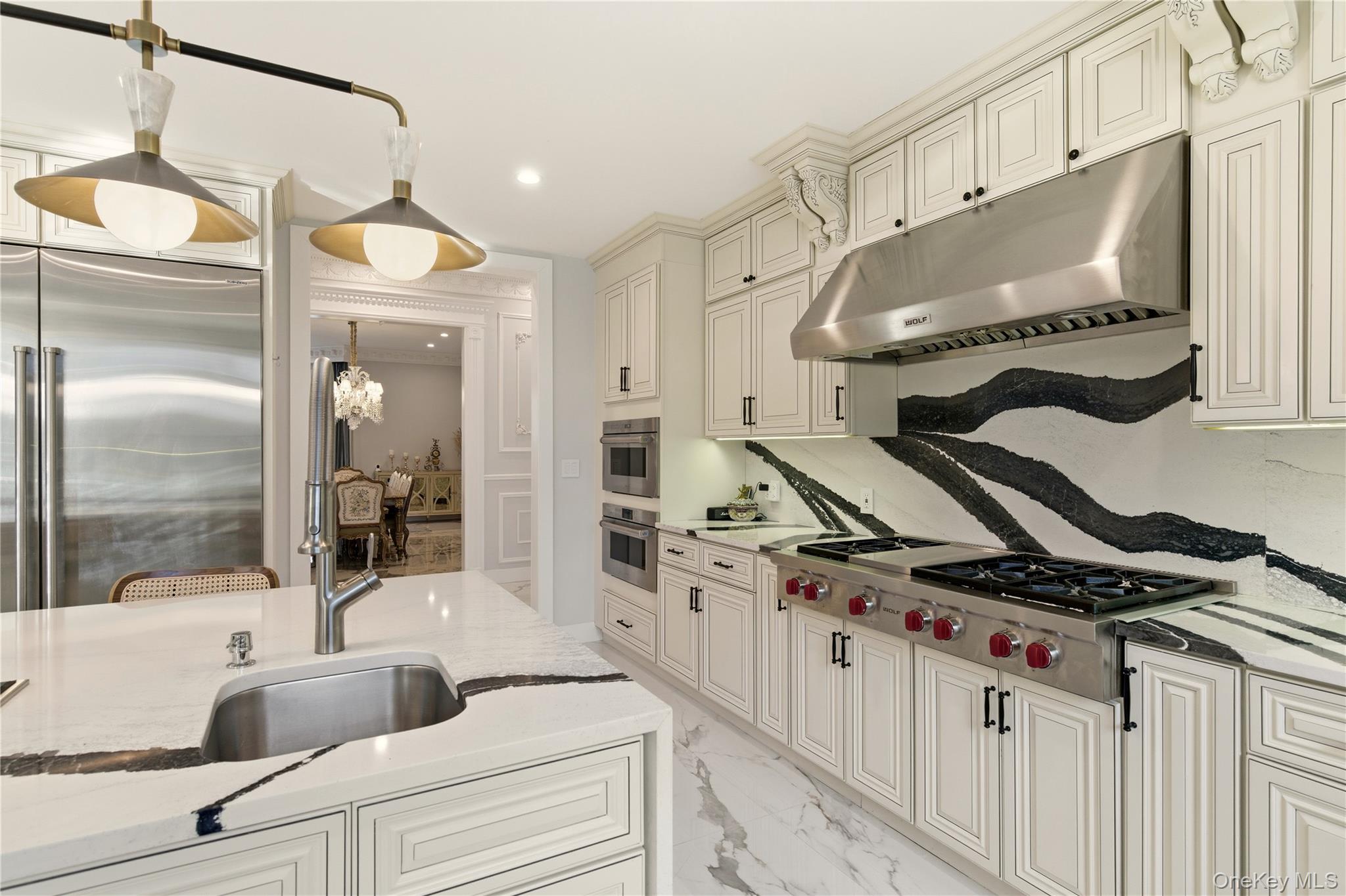 265 Laurel Lane Syosset, NY 11791 - Photo 14 of 48 a kitchen with stainless steel appliances granite countertop a sink and a refrigerator