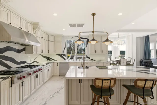 a kitchen with cabinets and chairs