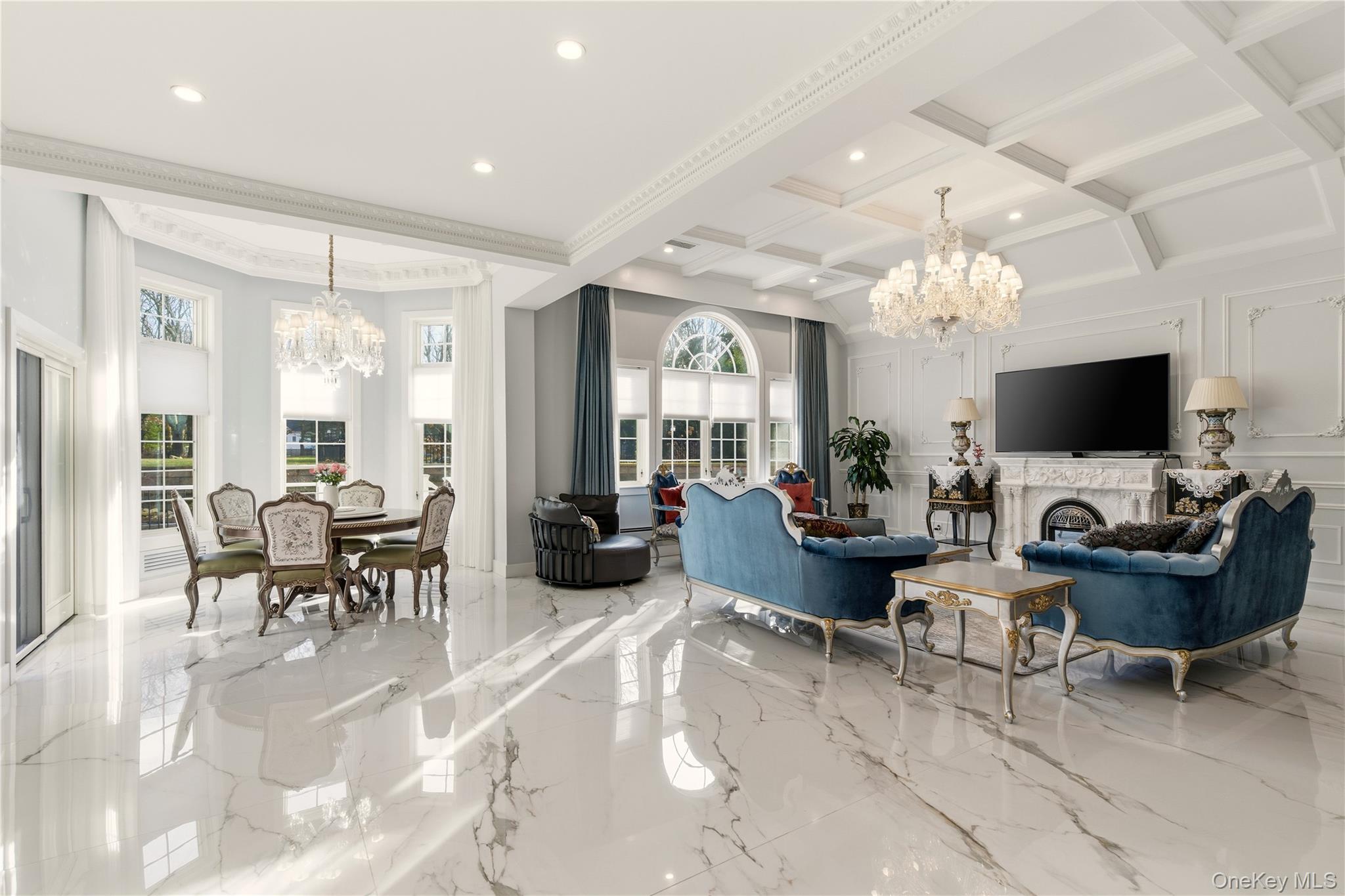 265 Laurel Lane Syosset, NY 11791 - Photo 17 of 48 a living room with furniture a chandelier and a flat screen tv