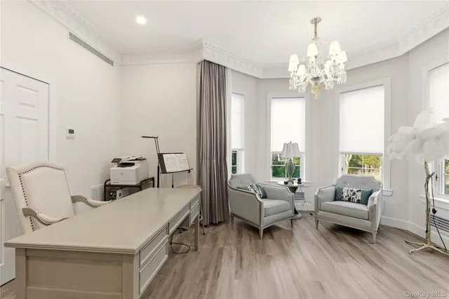 a view of a hallway with a table and chairs