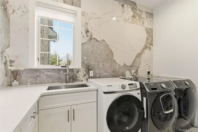 a vase of flowers sitting on a floor in front of a house