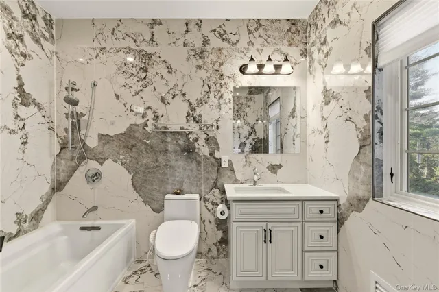 a spacious bedroom with a bed and a chandelier