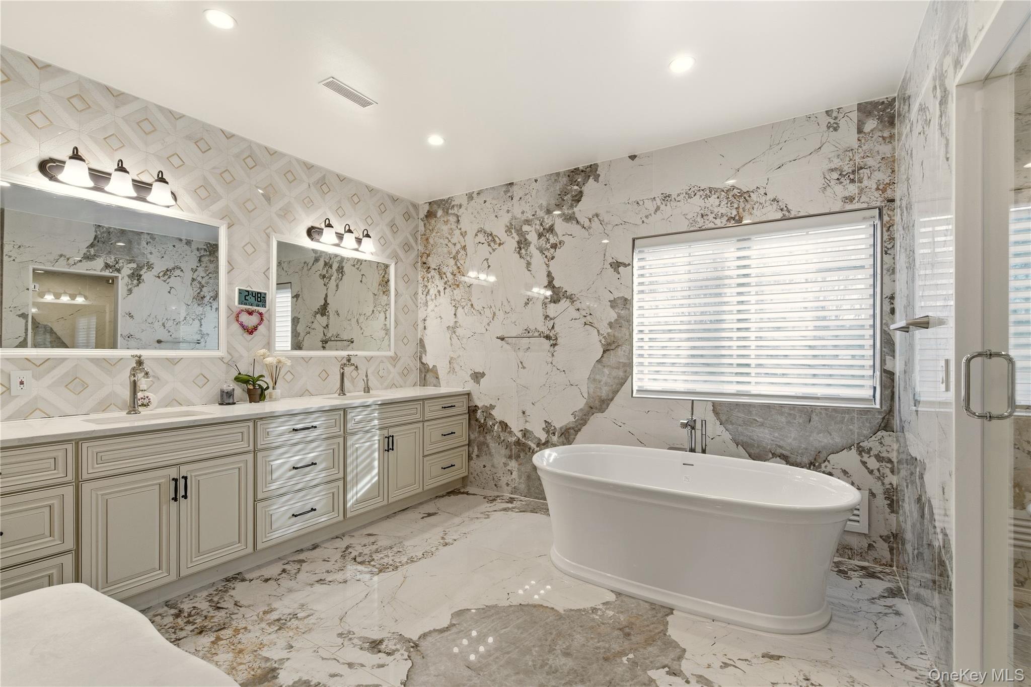 265 Laurel Lane Syosset, NY 11791 - Photo 35 of 48 a spacious bathroom with a double vanity sink toilet mirror and bathtub