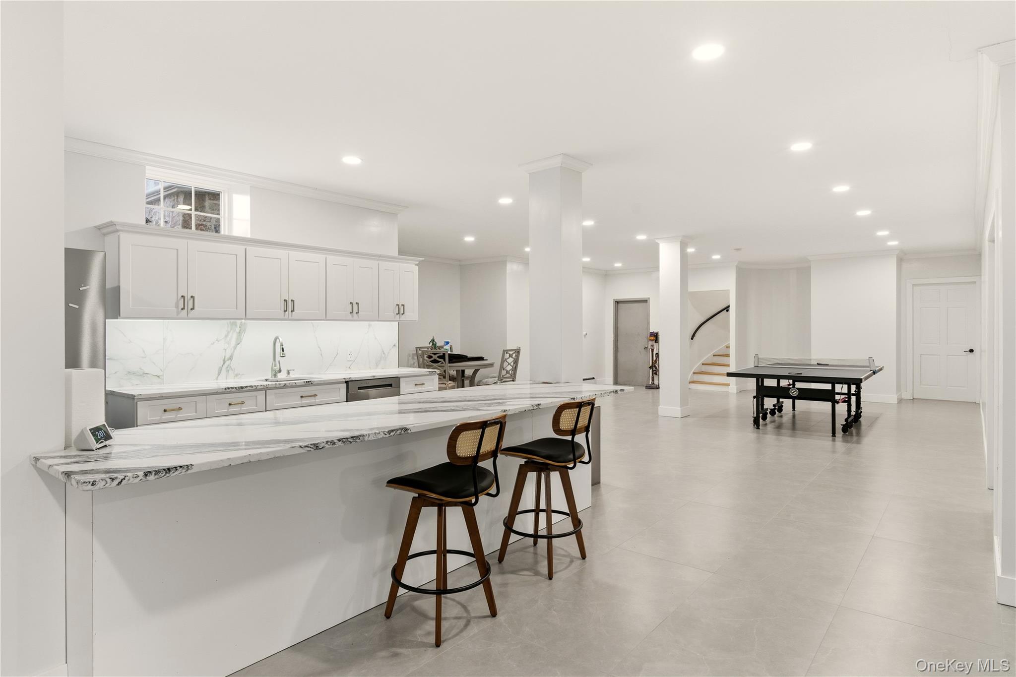 265 Laurel Lane Syosset, NY 11791 - Photo 39 of 48 a kitchen with a dining table chairs and view living room
