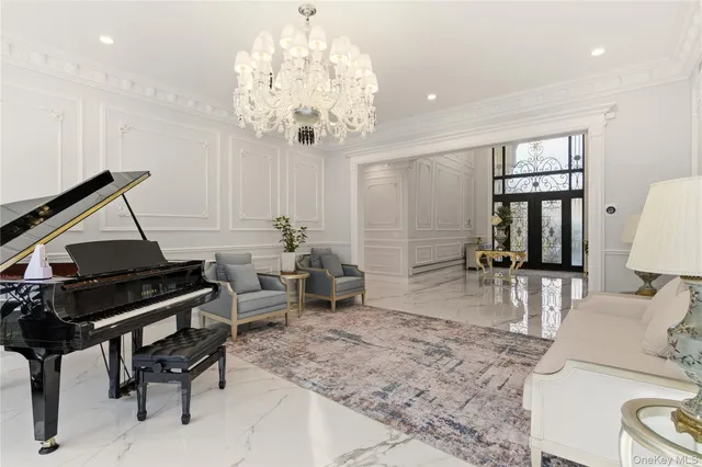a dining room with furniture a chandelier and window