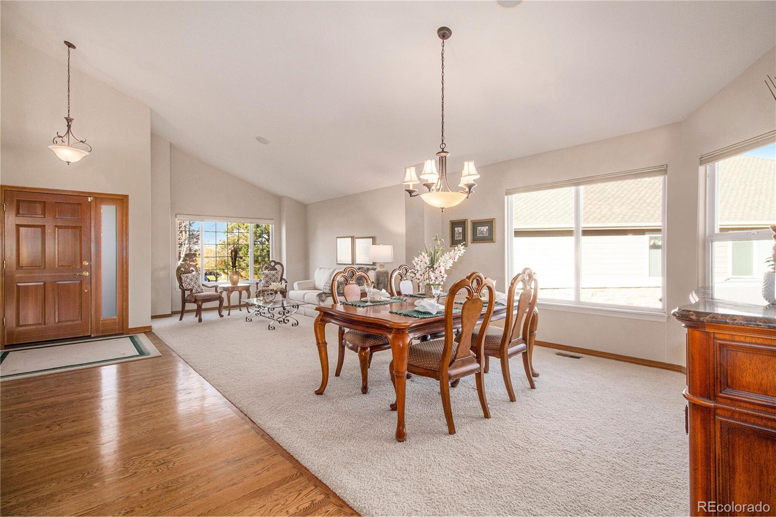 10604 Osceola Loop Westminster, CO 80031 - Photo 15 of 32 a dining room with furniture a chandelier and wooden floor