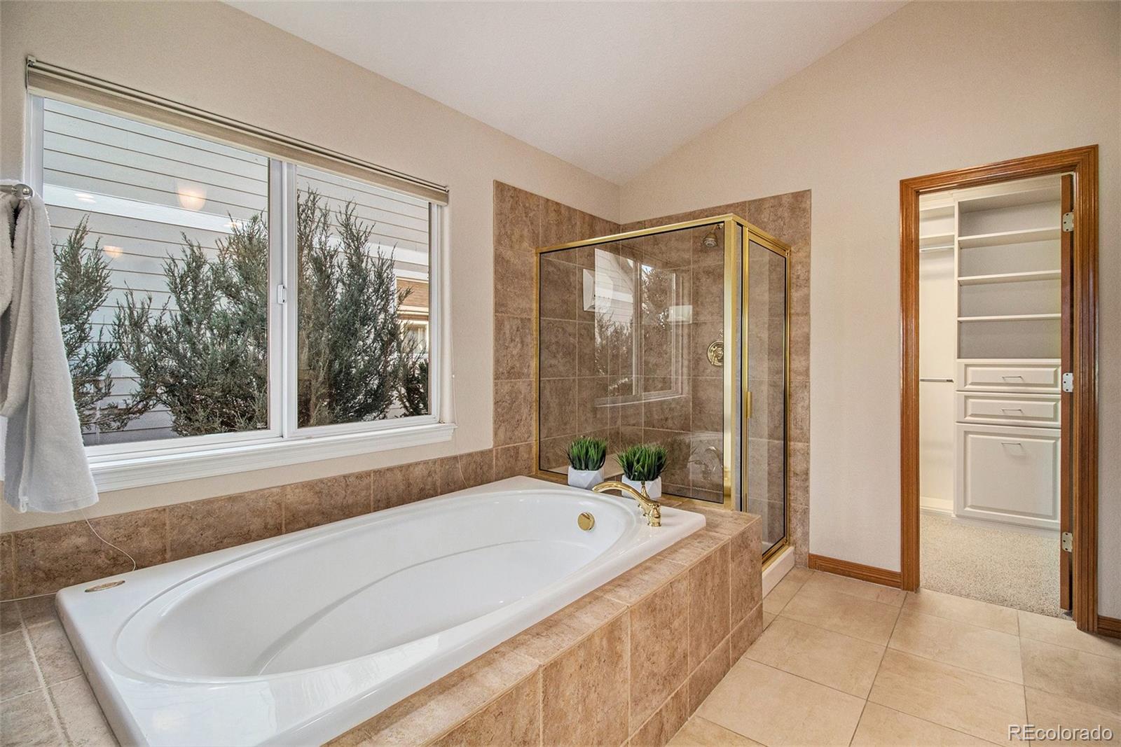 10604 Osceola Loop Westminster, CO 80031 - Photo 22 of 32 a spacious bathroom with bathtub and shower