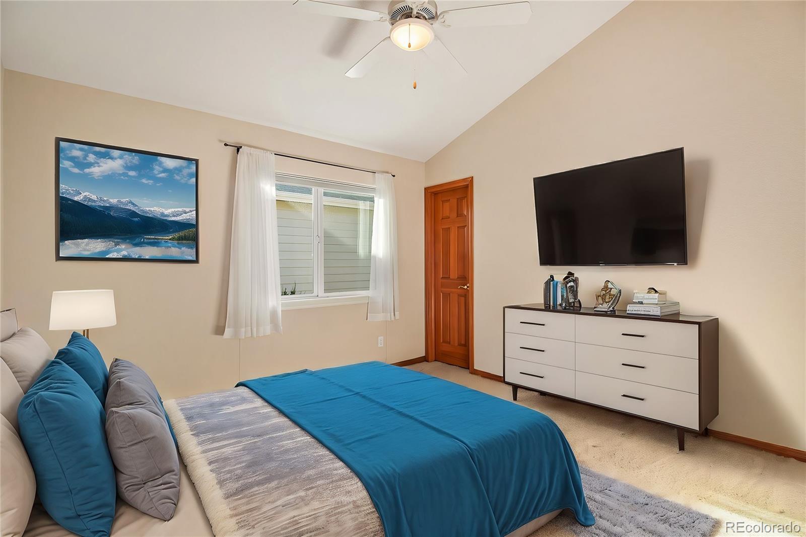 10604 Osceola Loop Westminster, CO 80031 - Photo 23 of 32 a bedroom with a bed and a flat screen tv