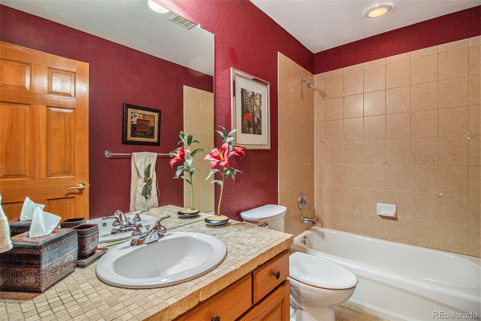 10604 Osceola Loop Westminster, CO 80031 - Photo 24 of 32 a bathroom with a granite countertop sink and a mirror