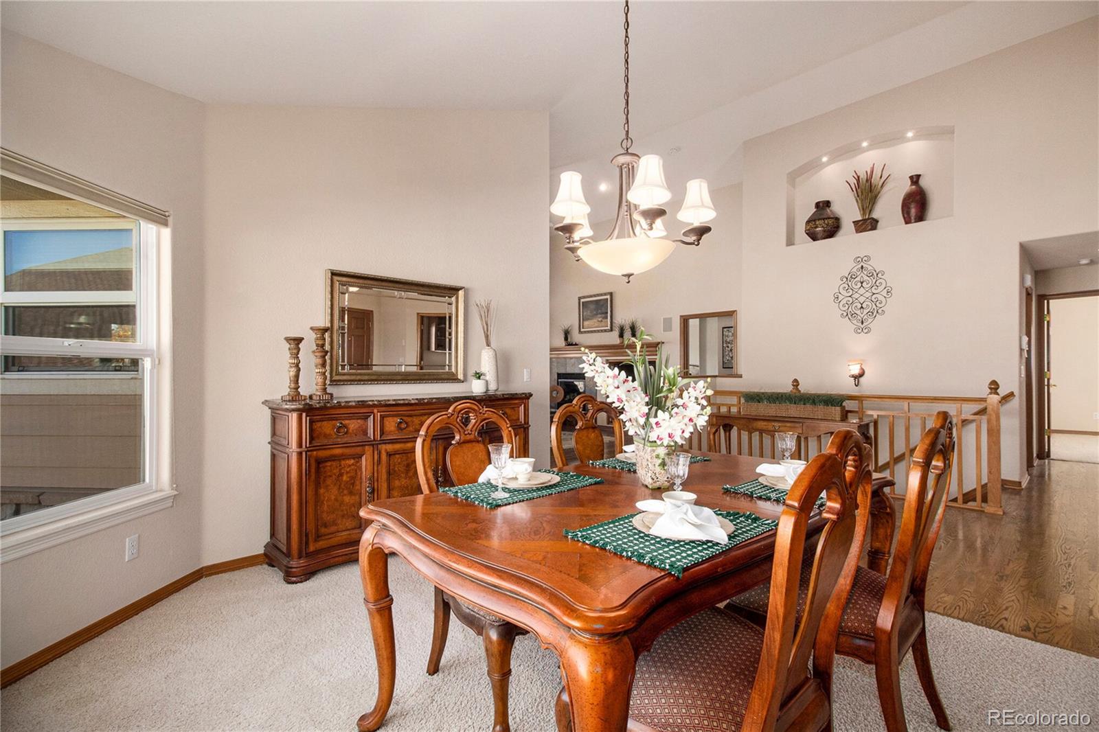 10604 Osceola Loop Westminster, CO 80031 - Photo 27 of 32 a view of a dining room with furniture a chandelier and wooden floor