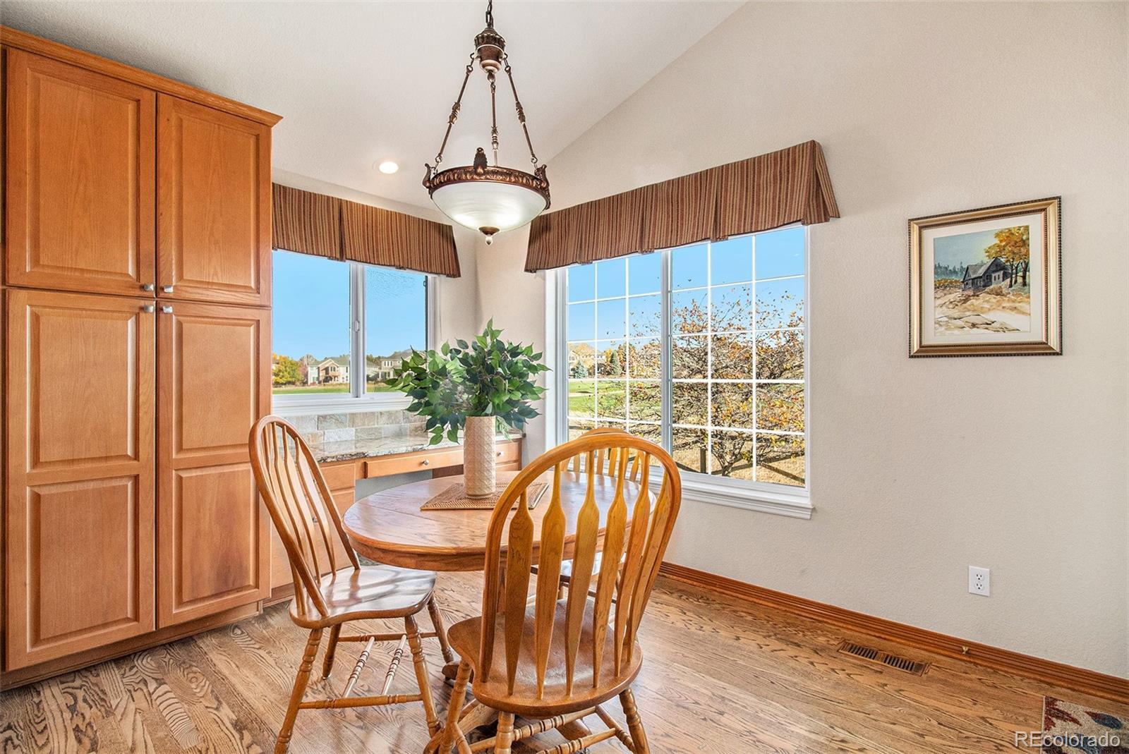 10604 Osceola Loop Westminster, CO 80031 - Photo 29 of 32 a view of a dining room with furniture window and wooden floor