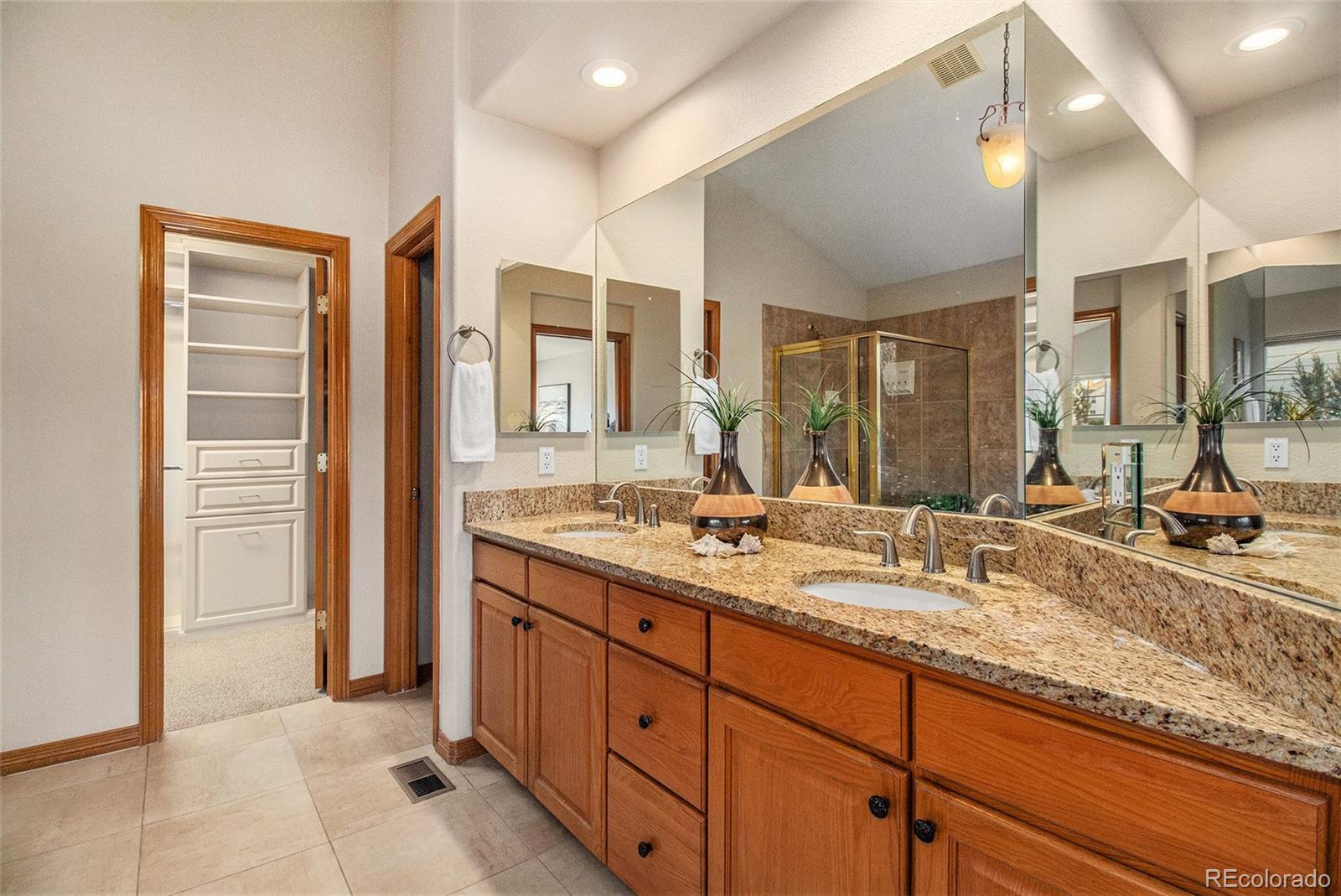 10604 Osceola Loop Westminster, CO 80031 - Photo 8 of 32 a bathroom with a granite countertop sink mirror and