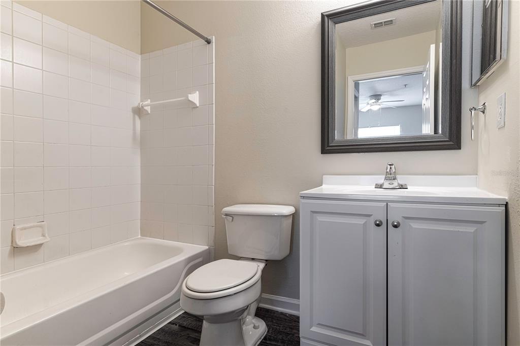 4324 South Kirkman Road, Unit 1103 Orlando, FL 32811 - Photo 13 of 20 a bathroom with a toilet sink and mirror