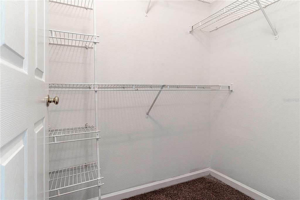 4324 South Kirkman Road, Unit 1103 Orlando, FL 32811 - Photo 14 of 20 a view of a room with racks on the wall