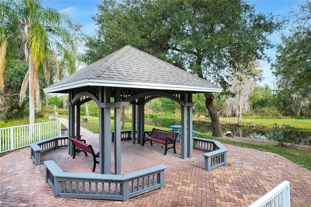 a view of a patio with a table chairs and a backyard