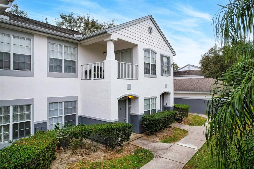 4324 South Kirkman Road, Unit 1103 Orlando, FL 32811 - Photo 2 of 20 a front view of a house with a yard