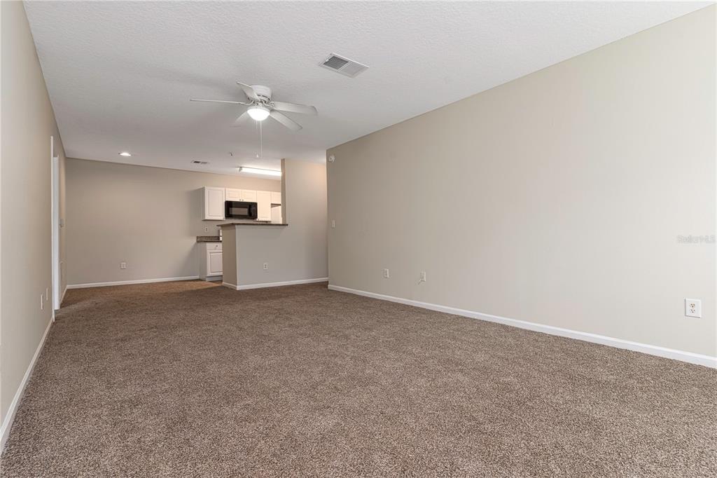 4324 South Kirkman Road, Unit 1103 Orlando, FL 32811 - Photo 6 of 20 a view of empty room with kitchen and window