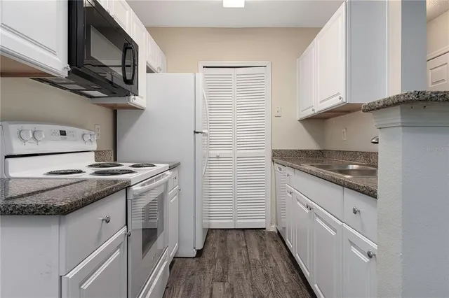 a kitchen with stainless steel appliances granite countertop a stove and a sink