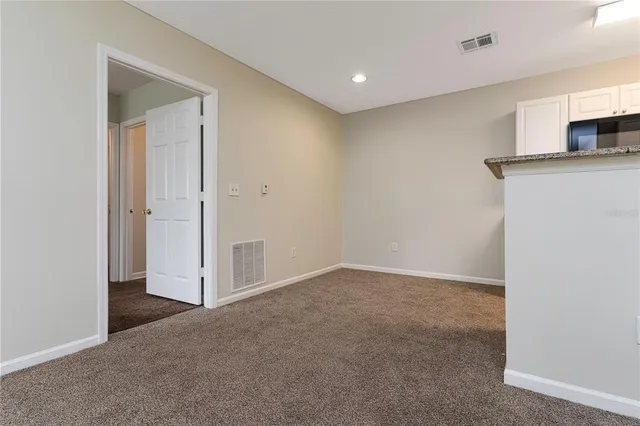 a view of a kitchen with a sink and a refrigerator
