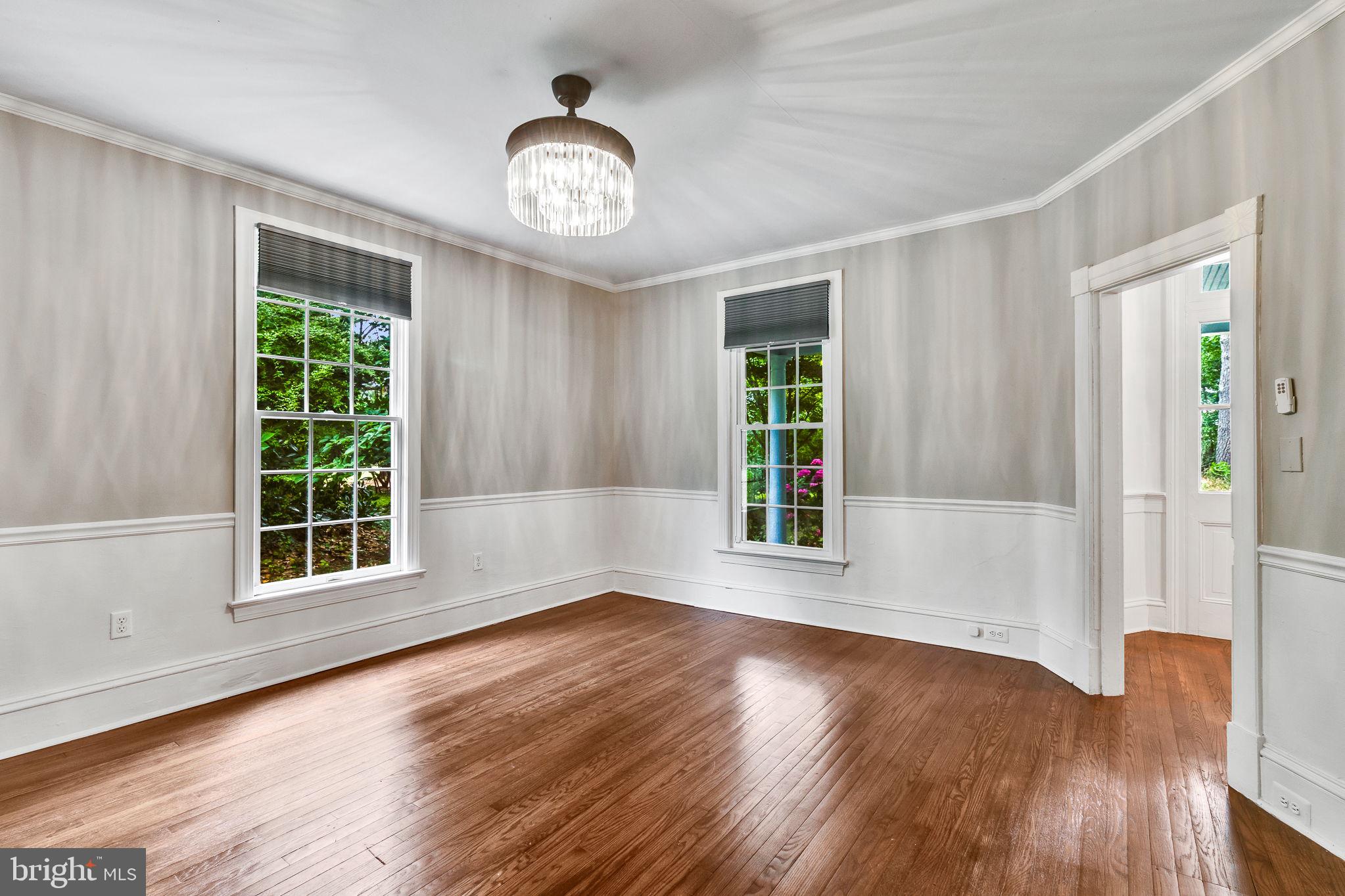 3952 Irvington Road Irvington, VA 22480 - Photo 12 of 77 a view of an empty room with wooden floor and a window