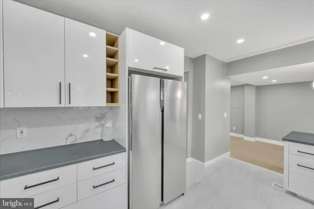 a view of a kitchen with white cabinets