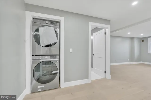 a room with wooden floor and mirror