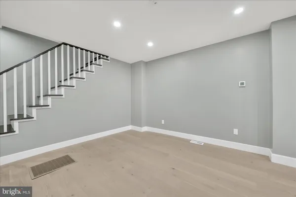 an empty room with wooden floor