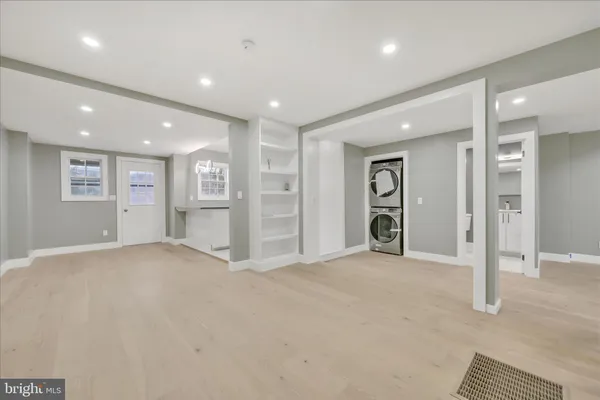 an empty room with closet and windows