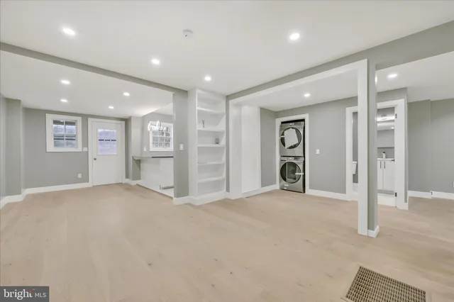 an empty room with closet and windows