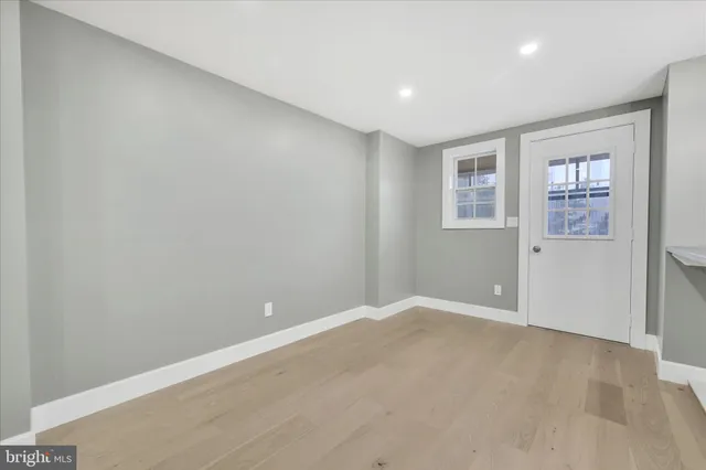 an empty room with windows and closet