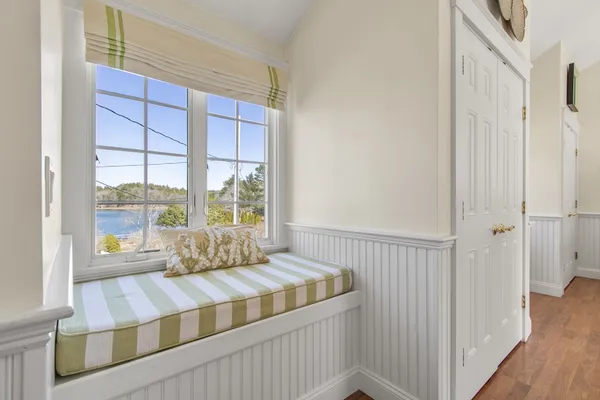 a spacious bedroom with a bed window and a table
