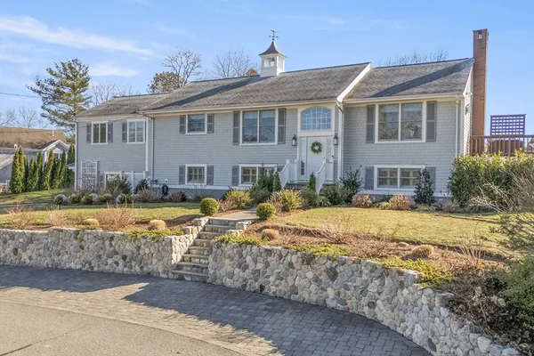 a front view of a house with swimming pool and porch