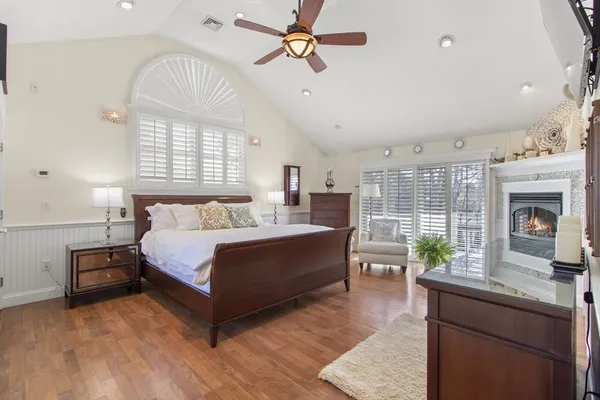 a spacious bedroom with a bed and a chandelier