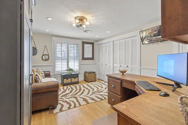 a bedroom with a bed and wooden cabinets