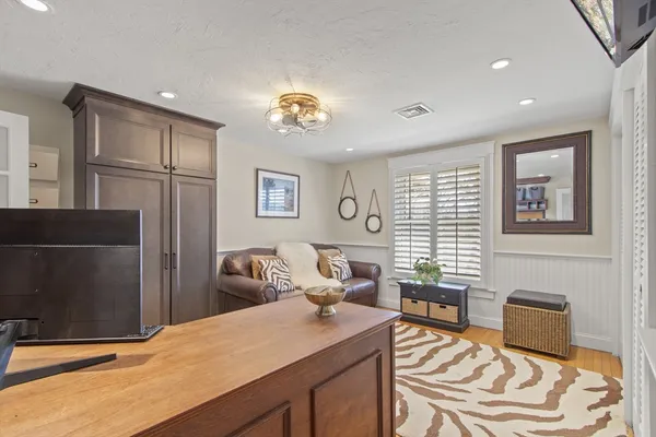 a bathroom with a bathtub sink mirror toilet and next to a window