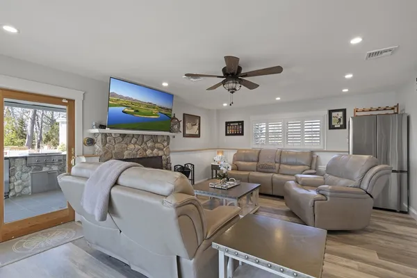a living room with furniture a fireplace and a flat screen tv