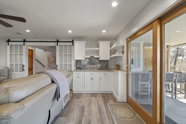 a living room with furniture and a wooden floor